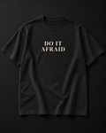 DO IT AFRAID black tee photographic mockup with complete cream serif print