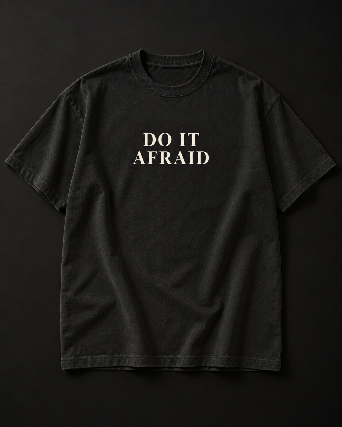 DO IT AFRAID black tee photographic mockup with complete cream serif print