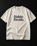 Habits Decide. heavyweight tee in bone with a bold serif chest print.