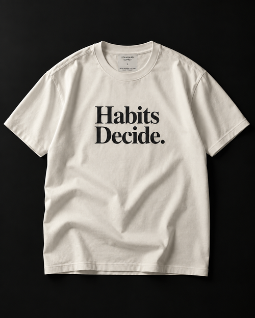 Habits Decide. heavyweight tee in bone with a bold serif chest print.