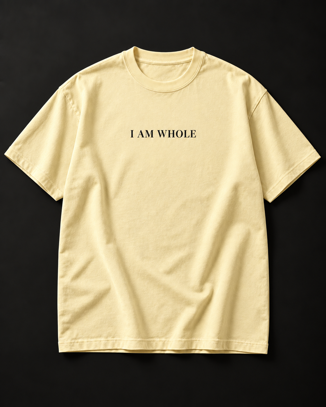 I AM WHOLE heavyweight tee in buttermilk with a small serif chest print.