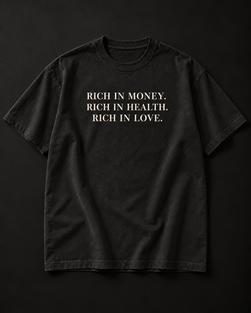 RICH IN MONEY. RICH IN HEALTH. RICH IN LOVE. heavyweight tee in washed black with a three-line stacked serif front print.