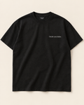 The Discipline heavyweight tee in near-black with a small serif left chest print reading Decide your habits.