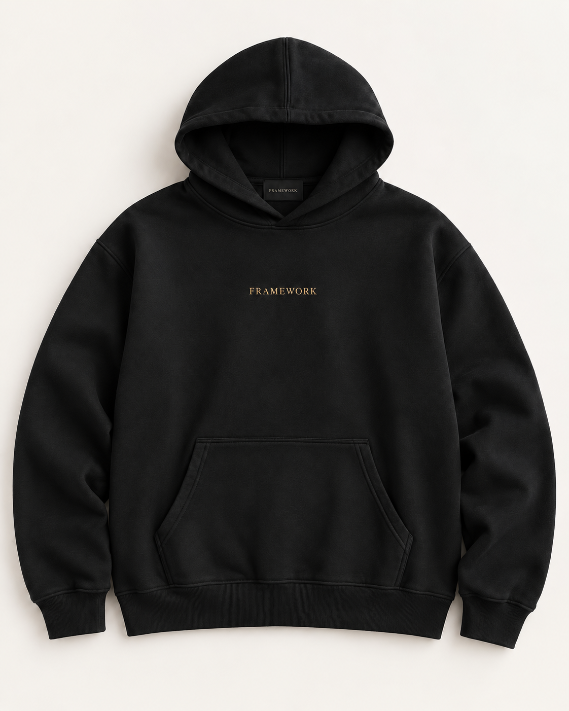 The Signature heavyweight hoodie in near-black with FRAMEWORK embroidered in muted gold on the chest.